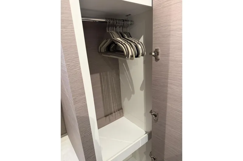 Slide: The Image of 2024 Fountaine Pajot MY5 yacht closet with hangers, showcasing sleek interior design. - 30