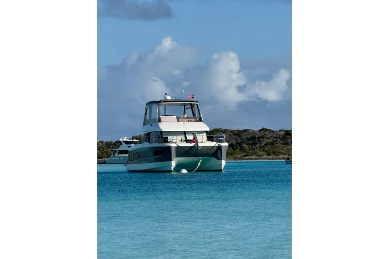 Slide: The Image of 2024 Fountaine Pajot MY5 yacht anchored in clear blue waters. - 6