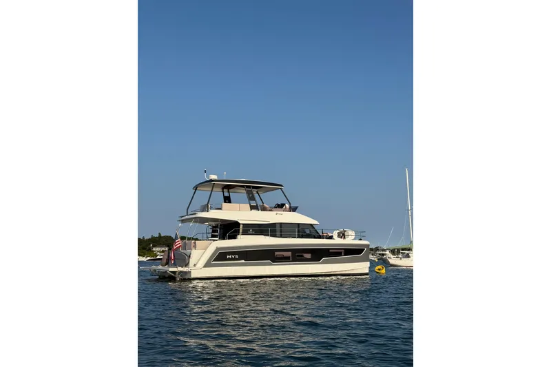 Slide: The Image of 2024 Fountaine Pajot MY5 yacht on calm water under clear blue sky. - 7