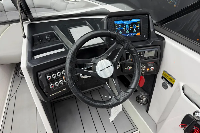 Slide: The Image of 2019 Moomba Mojo boat dashboard with steering wheel and digital display. - 11