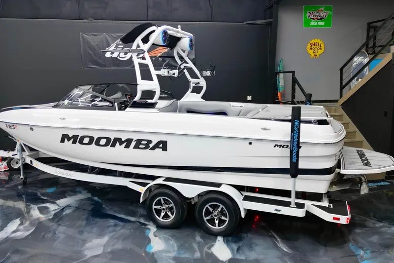 Slide: The Image of 2019 Moomba Mojo boat on trailer in showroom, featuring sleek design and modern wakeboard tower. - 3