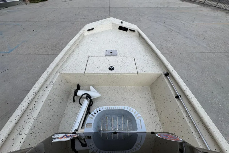 Slide: The Image of 2012 Xpress 1650VJF boat interior with speckled deck and trolling motor. - 11