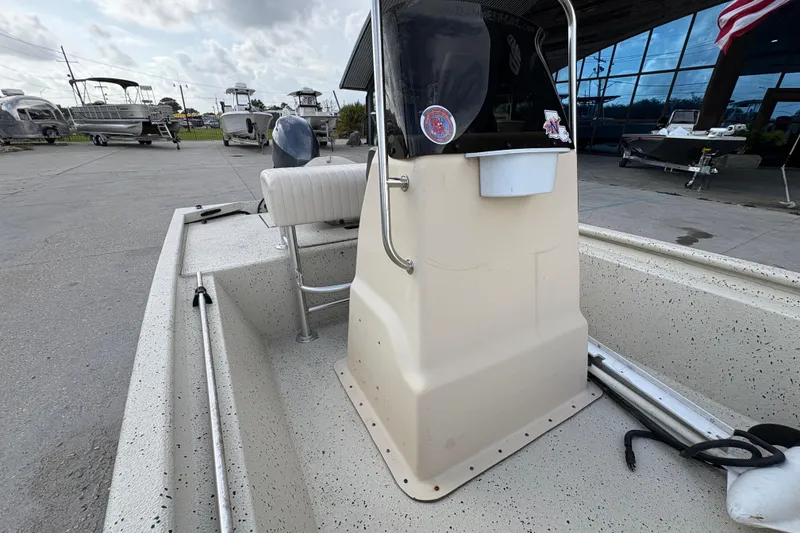 Slide: The Image of 2012 Xpress 1650VJF boat interior with console, parked at a marina. - 13