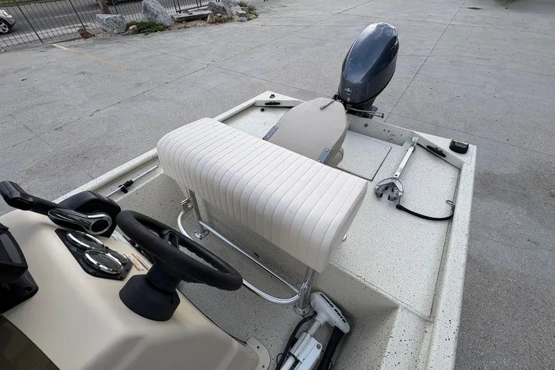 Slide: The Image of 2012 Xpress 1650VJF boat interior with steering wheel and motor. - 15