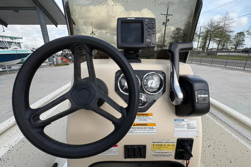 Slide: The Image of Steering console of 2012 Xpress 1650VJF boat with Yamaha controls and gauges. - 16
