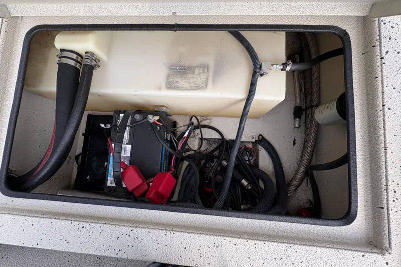 Slide: The Image of Battery compartment of a 2012 Xpress 1650VJF boat with cables and hoses. - 18