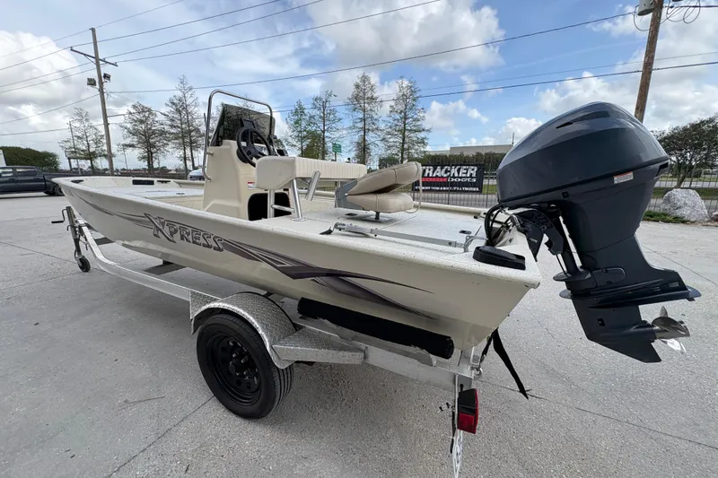 Slide: The Image of 2012 Xpress 1650VJF boat on trailer with outboard motor, parked outdoors. - 5