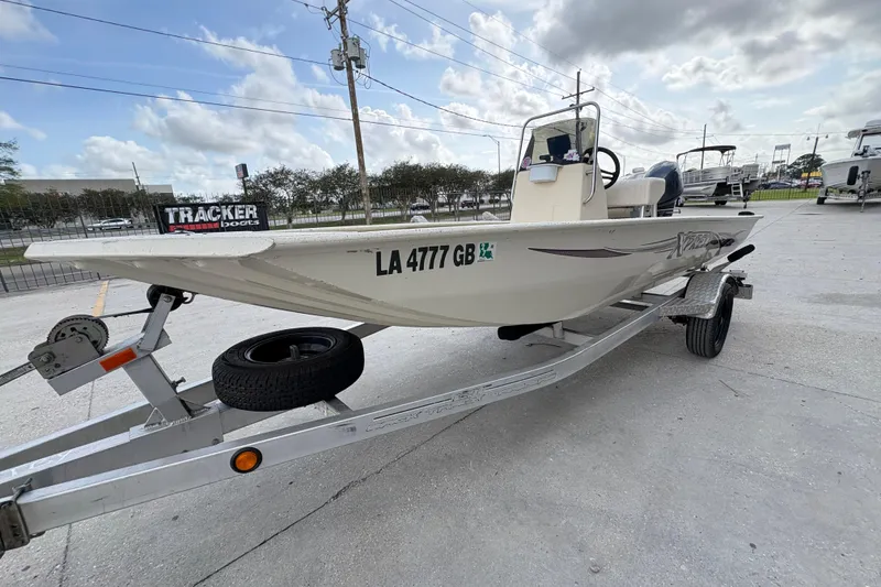 Slide: The Image of 2012 Xpress 1650VJF boat on trailer, parked outdoors under cloudy sky. - 7