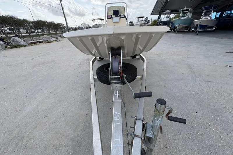 Slide: The Image of 2012 Xpress 1650VJF boat on trailer in outdoor storage area. - 8