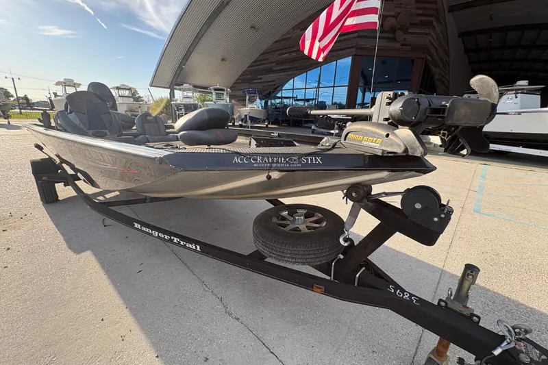 Slide: The Image of 2016 Ranger RT188 fishing boat on trailer, parked outside with American flag in background. - 10