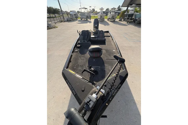 Slide: The Image of 2016 Ranger RT188 fishing boat with seating and trolling motor, parked outdoors. - 11