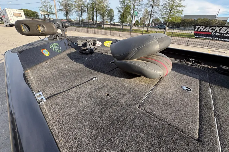 Slide: The Image of 2016 Ranger RT188 boat deck with seat and fishing equipment, parked outdoors. - 13