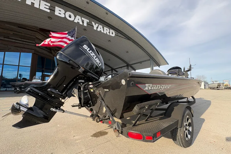 Slide: The Image of 2016 Ranger RT188 boat with Suzuki motor at dealership, American flag in background. - 4