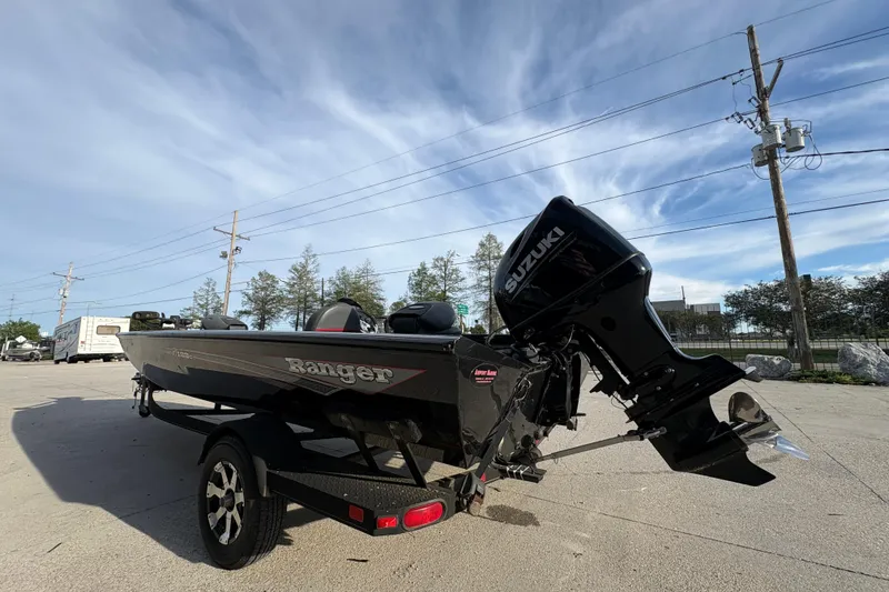 Slide: The Image of 2016 Ranger RT188 boat with Suzuki outboard motor on a trailer, parked outdoors. - 6