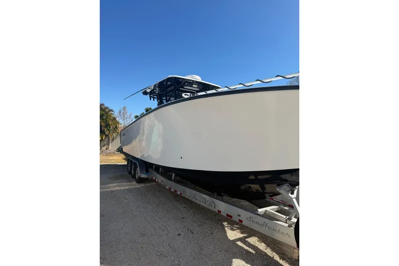 The Image of 2016 SeaHunter 35 Tournament boat on trailer under clear blue sky. - 1