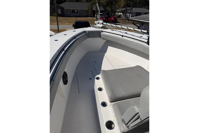 Slide: The Image of 2016 SeaHunter 35 Tournament boat interior with cushioned seating and rod holders. - 11