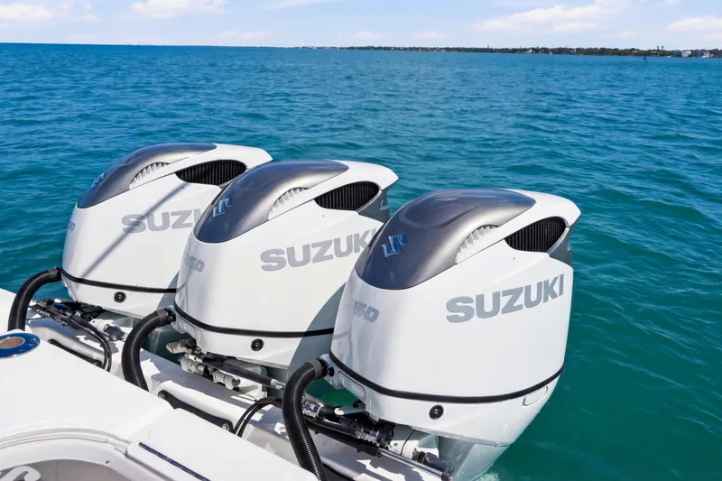 Slide: The Image of Triple Suzuki outboard engines on 2016 SeaHunter 35 Tournament boat in open water. - 16