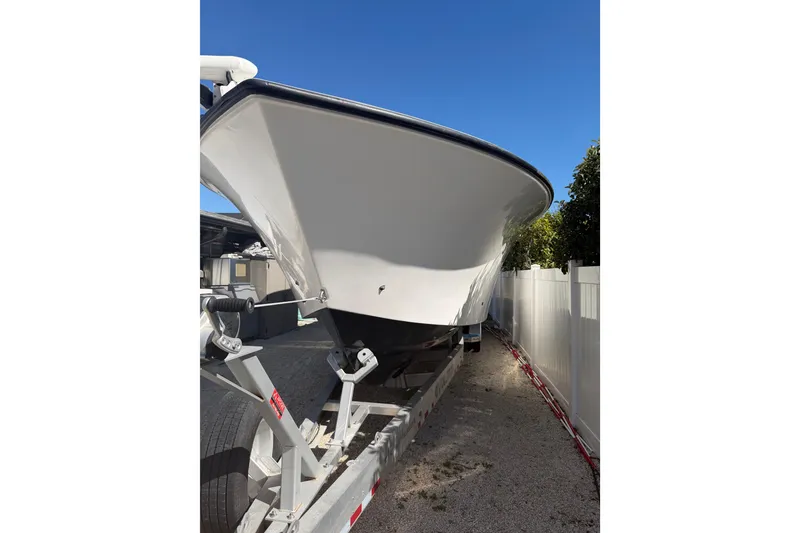 Slide: The Image of 2016 SeaHunter 35 Tournament boat on trailer, parked outdoors under clear blue sky. - 2
