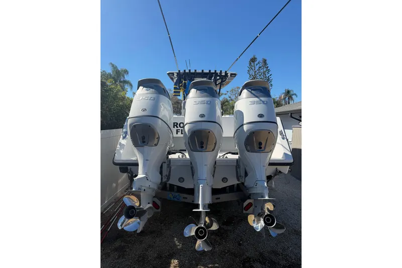 Slide: The Image of 2016 SeaHunter 35 Tournament boat with triple 350 horsepower engines, parked outdoors. - 3