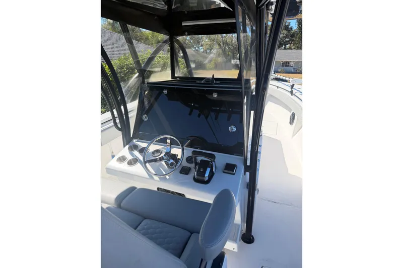 Slide: The Image of 2016 SeaHunter 35 Tournament boat cockpit with steering wheel and navigation controls. - 6