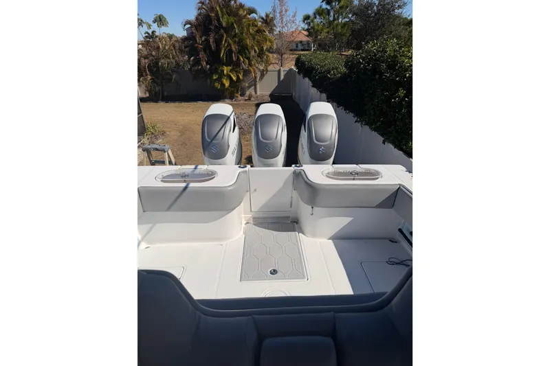 Slide: The Image of 2016 SeaHunter 35 Tournament boat with triple outboard engines, parked outdoors. - 7
