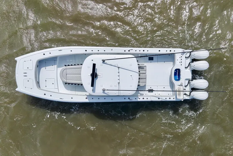 Slide: The Image of Aerial view of 2024 Freeman 38 boat with triple engines on water. - 10