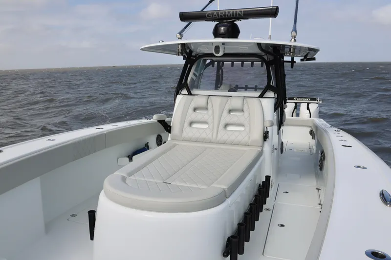 Slide: The Image of 2024 Freeman 38 boat with luxurious seating on open water. - 12