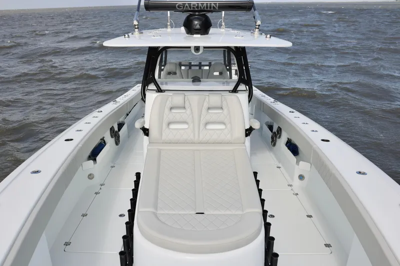 Slide: The Image of 2024 Freeman 38 boat with luxurious seating, equipped with Garmin technology, on open water. - 13