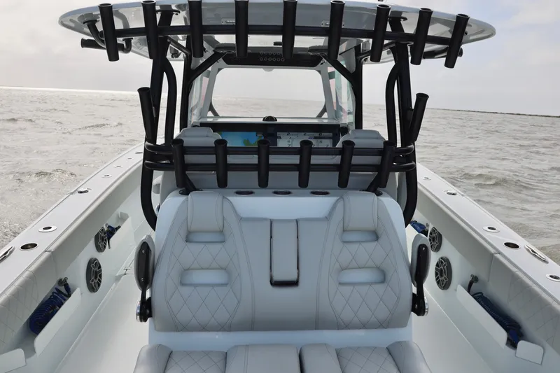Slide: The Image of 2024 Freeman 38 boat interior with luxurious seating and rod holders on open water. - 19