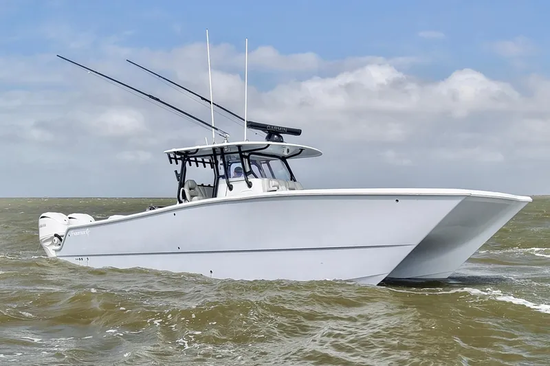 Slide: The Image of 2024 Freeman 38 boat navigating choppy waters under a cloudy sky. - 2