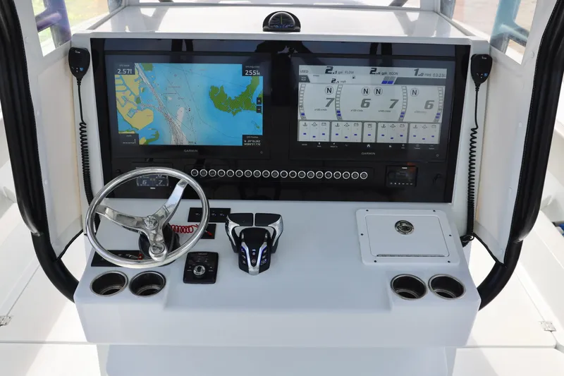 Slide: The Image of 2024 Freeman 38 boat dashboard with navigation screens and steering wheel. - 21