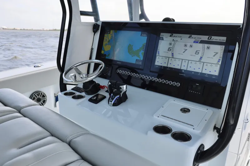 Slide: The Image of 2024 Freeman 38 boat dashboard with advanced navigation and control systems on open water. - 22
