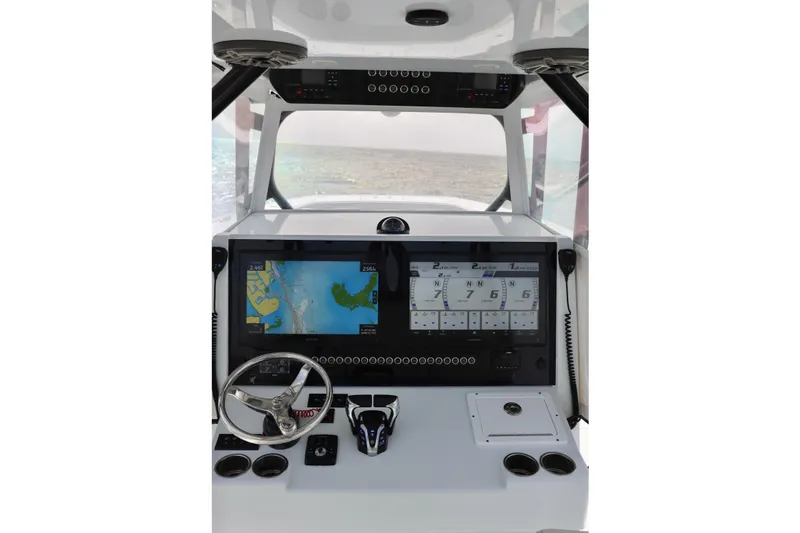 Slide: The Image of 2024 Freeman 38 boat dashboard with navigation screens and steering wheel. - 23