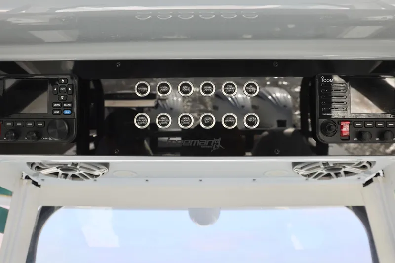 Slide: The Image of 2024 Freeman 38 boat dashboard with control panel and radio equipment. - 24