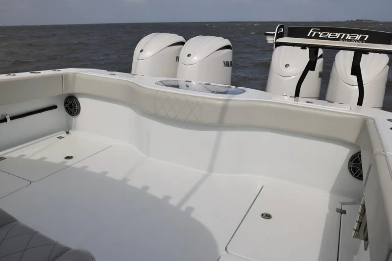 Slide: The Image of 2024 Freeman 38 boat deck with Yamaha engines, featuring spacious seating and modern design. - 28