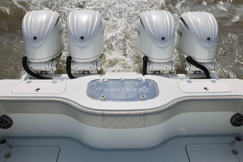 Slide: The Image of 2024 Freeman 38 boat with four powerful outboard engines on the water. - 29