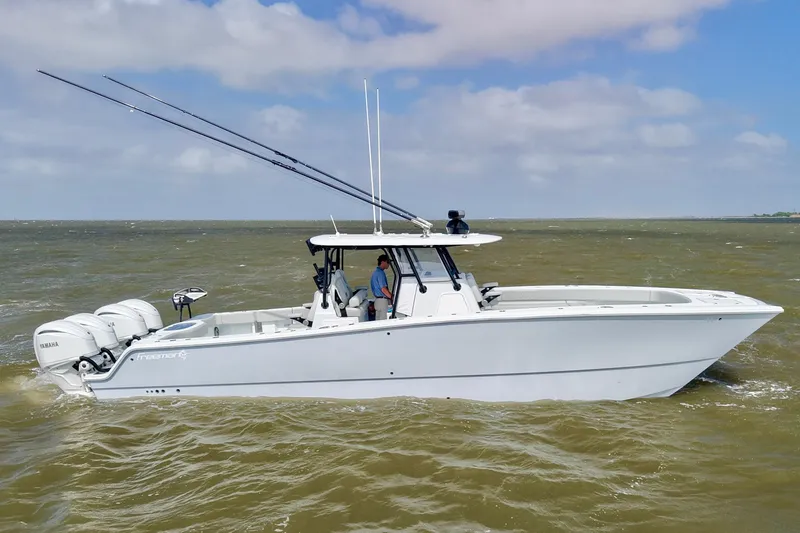 Slide: The Image of 2024 Freeman 38 boat on water, featuring multiple outboard engines and fishing rods. - 4