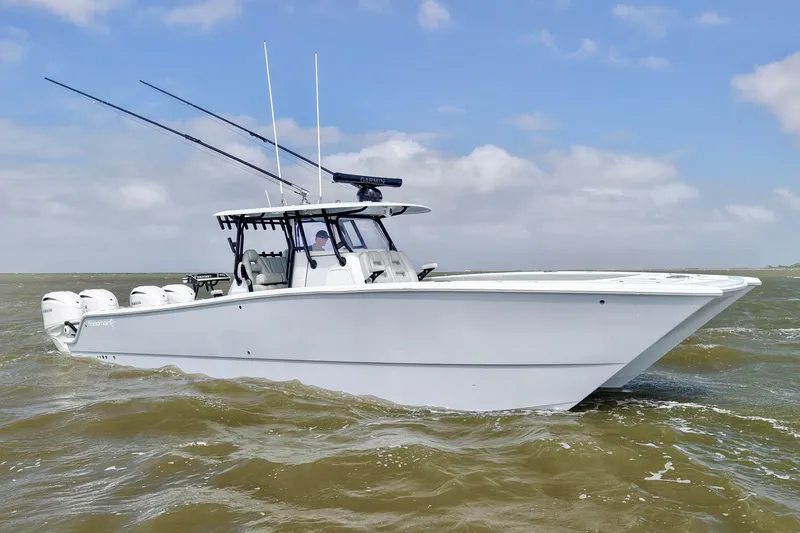 Slide: The Image of 2024 Freeman 38 boat cruising on open water under a clear sky. - 5