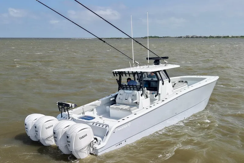 Slide: The Image of 2024 Freeman 38 boat with Yamaha engines cruising on open water. - 8