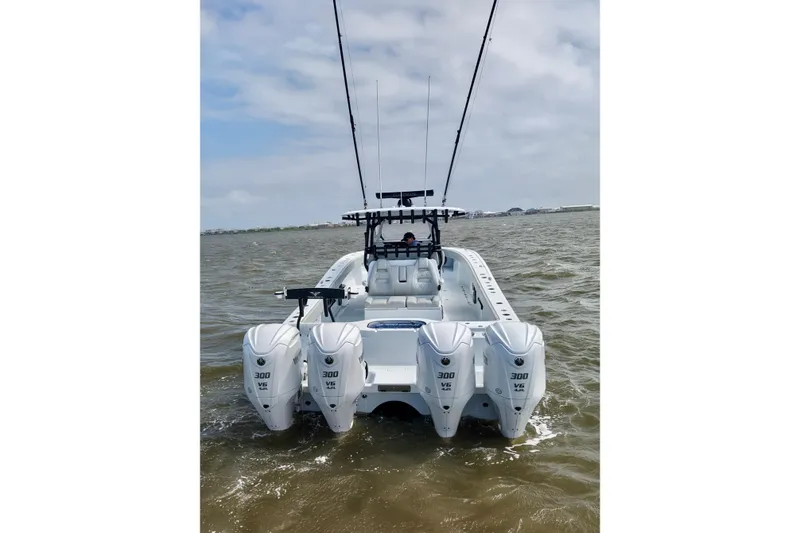 Slide: The Image of 2024 Freeman 38 boat with four powerful outboard engines on open water. - 9