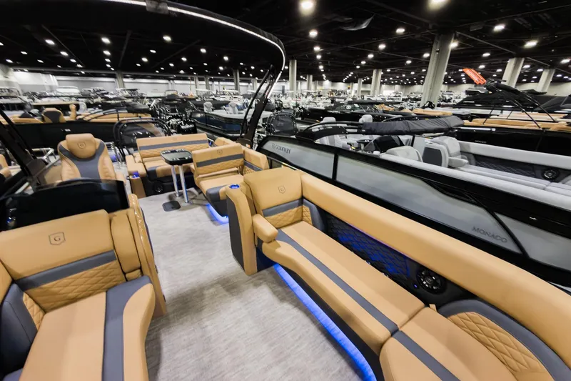 Slide: The Image of Luxurious 2026 Godfrey Monaco 255 pontoon boat interior with tan seating and modern design. - 10