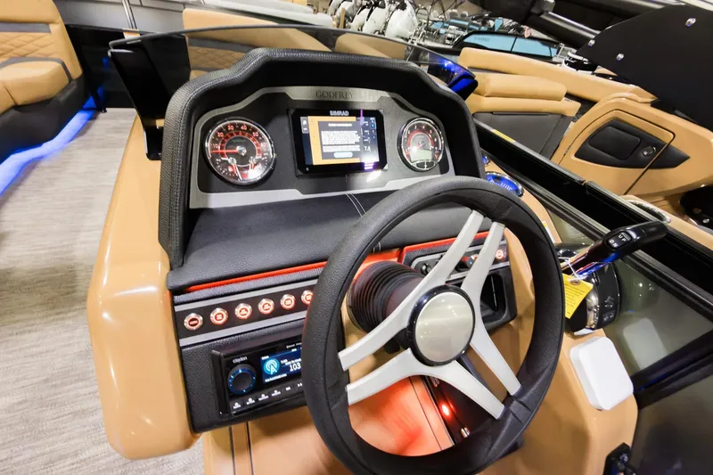 Slide: The Image of Steering console of 2026 Godfrey Monaco 255 Single Flip Lounge boat, featuring modern controls and displays. - 12