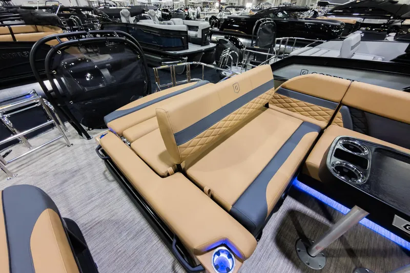 Slide: The Image of Luxurious interior of 2026 Godfrey Monaco 255 pontoon boat with tan and gray seating. - 22