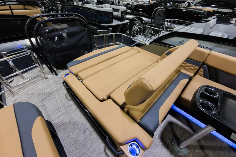 Slide: The Image of Luxurious 2026 Godfrey Monaco 255 boat with tan flip lounge seating and modern design. - 23