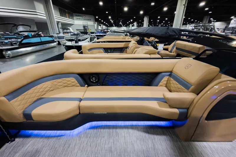 Slide: The Image of 2026 Godfrey Monaco 255 Single Flip Lounge boat interior with luxurious tan seating and ambient lighting. - 6