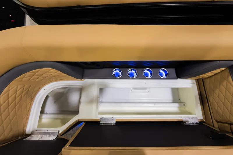 Slide: The Image of 2026 Godfrey Monaco 255 SFL boat interior with tan seating and illuminated controls. - 8