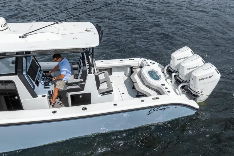 Slide: The Image of 2025 Yellowfin 36 Offshore boat with triple Mercury engines on the water. - 10
