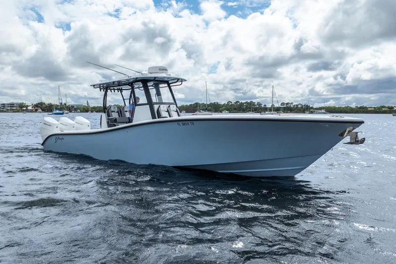 Slide: The Image of 2025 Yellowfin 36 Offshore boat cruising on a cloudy day. - 11