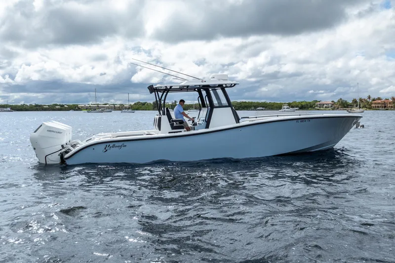 Slide: The Image of 2025 Yellowfin 36 Offshore boat on water, featuring sleek design and powerful Mercury engine. - 12