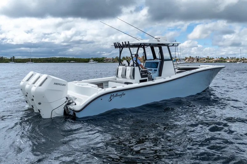 Slide: The Image of 2025 Yellowfin 36 Offshore boat with triple Mercury engines on open water. - 13
